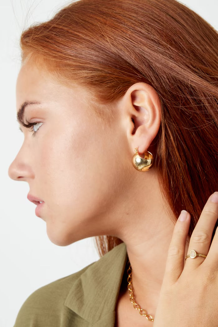 Statement ball earrings made of gold-colored stainless steel
